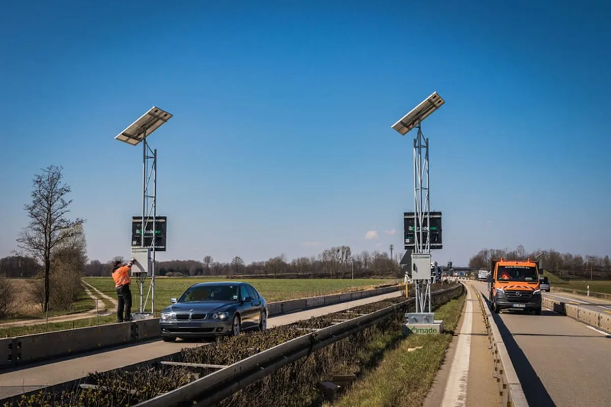Aufbau der mobilen LED-Stauwarnanlage an der A3 bei Metten mit Monteur und Einsatzfahrzeug